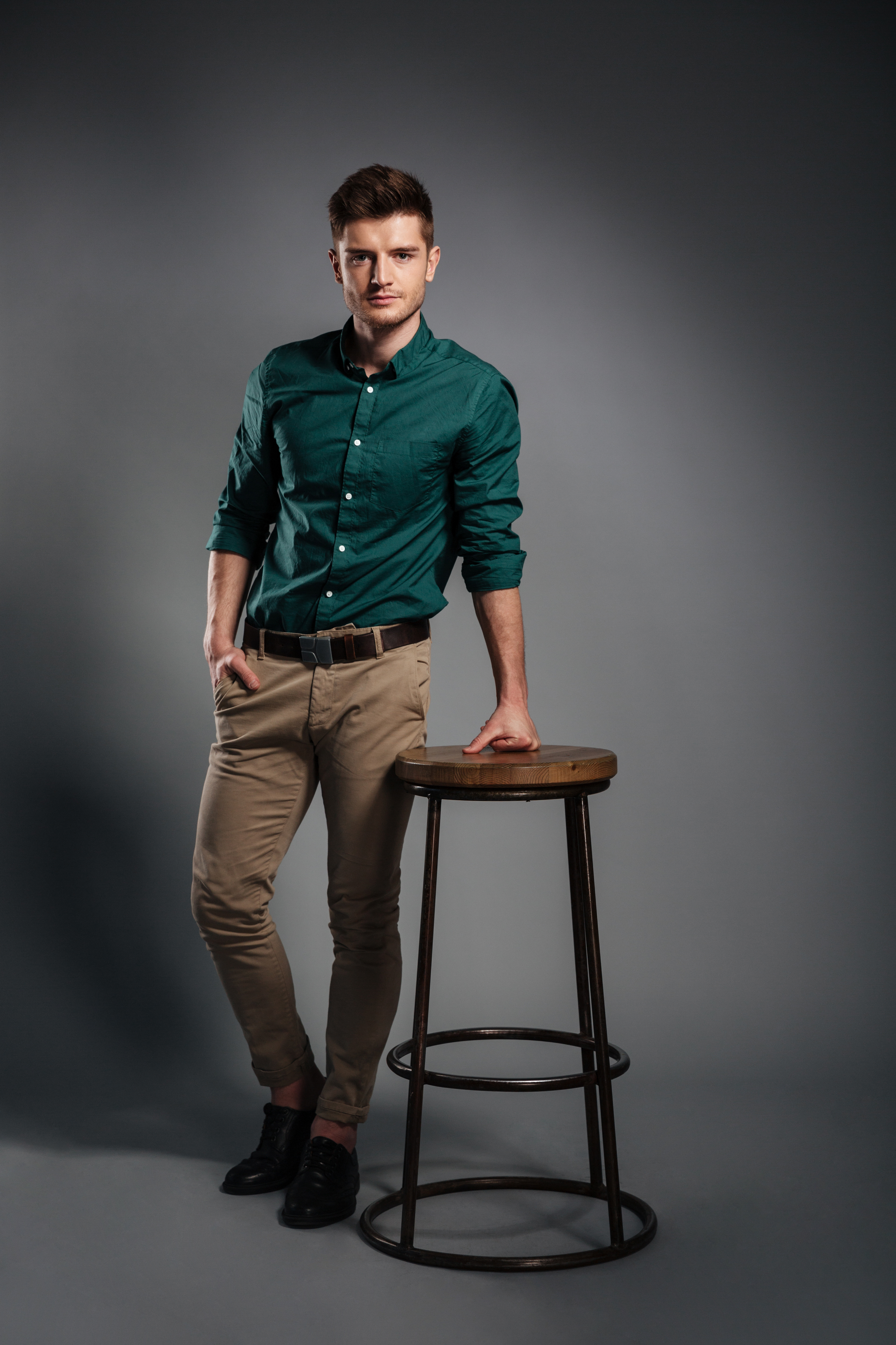 serious-young-man-standing-isolated-grey